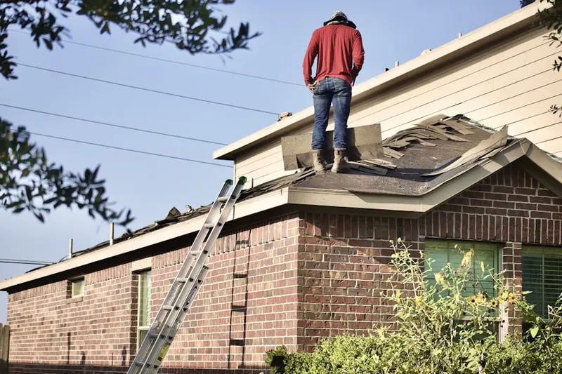 Professional roofer working on a residential roof in Northpark Square